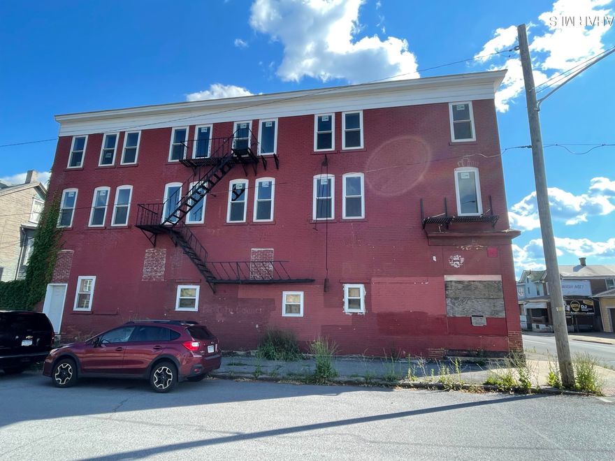 Investors! 70% Remodeled, 6 Unit-3 Story, High End Apartment Bldg. Each Floor has two Units. First Floor 2 Units are ADA. All Apts have 2BR, Full Bath, Eat-In Kitchen & Living Room. Approx 800 sq ft each. Units have their own 125 amp Electric Panel Box, and wall mounted Water on Demand Water Heaters. The Building has 200 amp service. Basement is heated. Building has rough-in Plumbing & Wiring including Fire Alarms. There is a Furnace for each floor with individual Thermostats. Windows are new insulated dbl hung and casement. New subfloors throughout. Next to the building is a foundation for a Laundromat or Off St Parking. Property is being Sold As Is. New Appraisal Report is available by request to Serious, Qualified Buyers only. Appraisal Report has projected Income & Expenses. Showings by Appointment Only.
