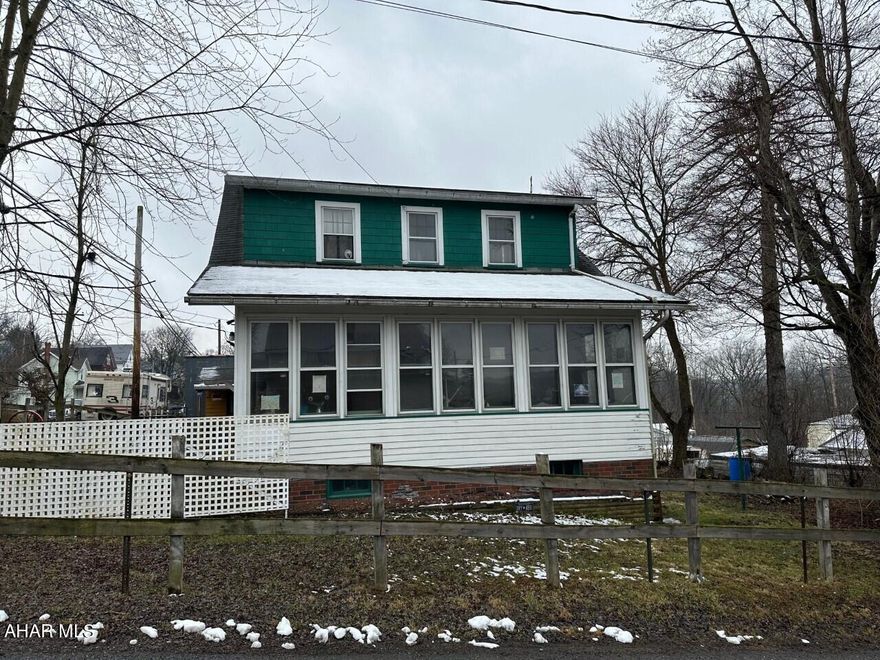 Two story home with hardwood floors.  Blown in insulation in exterior walls and attic.  Original wood doors and trim.  Enclosed front porch with heat.  Detached one car garage with covered deck the length of the garage.  Corner fenced in lot.