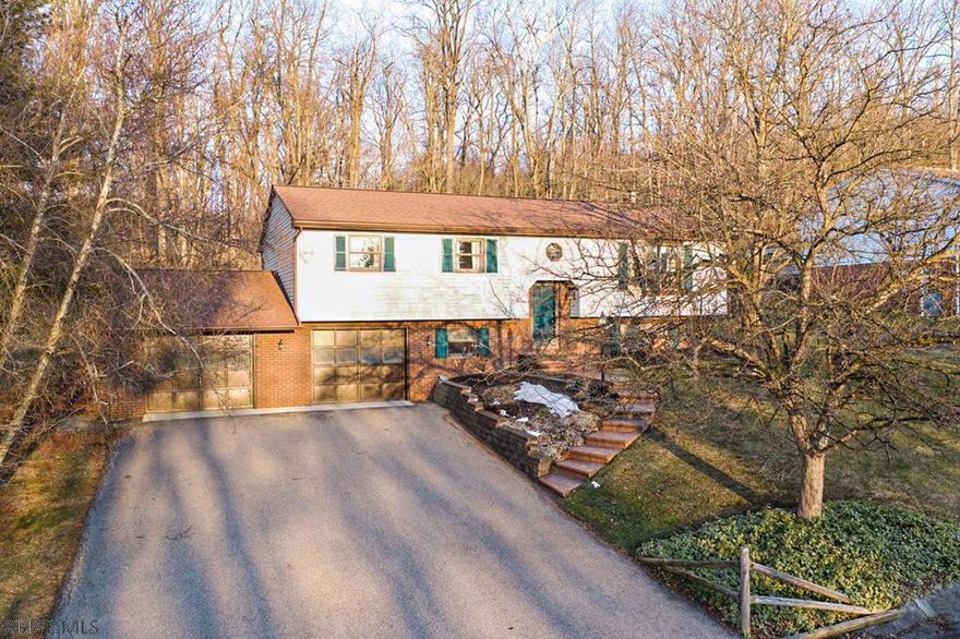 This move-in ready bi-level home is a rare find in today's real estate market.  Situated in the Rolling Hills Development of Hollidaysburg, this stunning home offers 3 bedrooms, 3 full baths, and a large 2 car garage.  The home is located at the top of the development and backs up to the woods for privacy.  The main level offers a large open kitchen with a formal dining room.  The dining room has a sliding glass door with access to the back patio.  There are three bedrooms on the main level, the master with an en-suite full bath.  There is new carpet and flooring throughout most of the main level of the the home as well.  The basement is finished and features a bathroom/laundry room, utility room, and wood burning stove.  Don't miss your opportunity to own this amazing home!