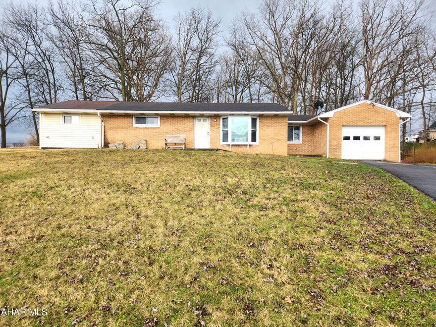 This beautifully renovated brick ranch home offers the perfect blend of comfort and countryside charm, set on a generous 0.97-acre lot in a peaceful rural setting. Inside, you'll find a spacious living rom that is an open concept to the kitchen.  Featuring plenty of hickory cabinets and a breakfast bar, the kitchen exudes functionality and style.  The large primary bedroom features newer carpeting and a large walk-in closet.  With a second bedroom, a playroom that could be a third bedroom, a full bathroom, and a convenient laundry room, this home offers one floor living that was all thoughtfully updated for modern living. With a solid slab foundation and central air conditioning, the home provides low-maintenance living and year-round comfort. 

Enjoy scenic views from the property and unwind in the spacious backyard, shaded by mature oak trees that add both beauty and privacy. The home also features an attached one-car garage for everyday convenience, along with a detached two-car garage and a separate storage shed--ideal for hobbies, tools, or extra storage needs.

Whether you're looking to buy your first home or donwsize into a manageable property with room to breathe, this move-in-ready home offers a wonderful opportunity to enjoy rural living at its best.  It's located just minutes from downtown Bedford, I-99, the PA Turnpike and Shawnee State Park.  Come have a look, it may be just what you've been looking for.  Buyer to confirm square footage and acreage.  Taxes do no reflect the Homestead Exemption.