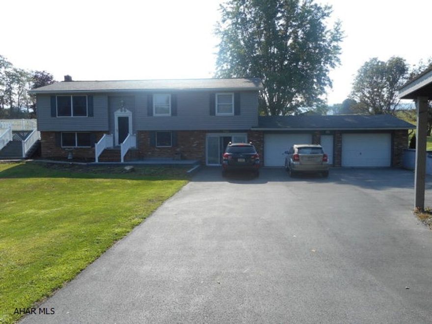 Immaculate home in a desirable location! Split entry home with hardwood floors, newer carpeting, granite counters and spacious multi level deck that overlooks an above ground pool. Large covered porch on back with incredible views and privacy. 1st floor with LR, kitchen/DR, 3 BR and 1 1/2 bath. Lower level with large bonus room, office, 3/4 bath and large family room. Large 2 car attached garage. Oversized 23' x 13' outbuilding. All on 1 acre in beautiful Snake Spring Township.