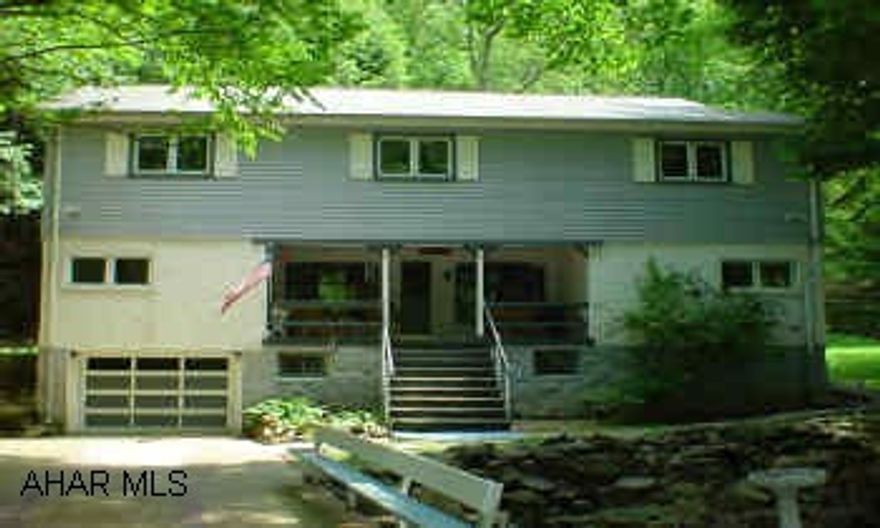 Beautiful wooded setting , almost 2-acres adjacent to state game lands, new roof, new siding and all windows, stone fireplace w/woodburner, 2nd floor laundry (could be 5th bedroom) babbling brook outside front porch, fruit trees, perennials oversize inground pool.