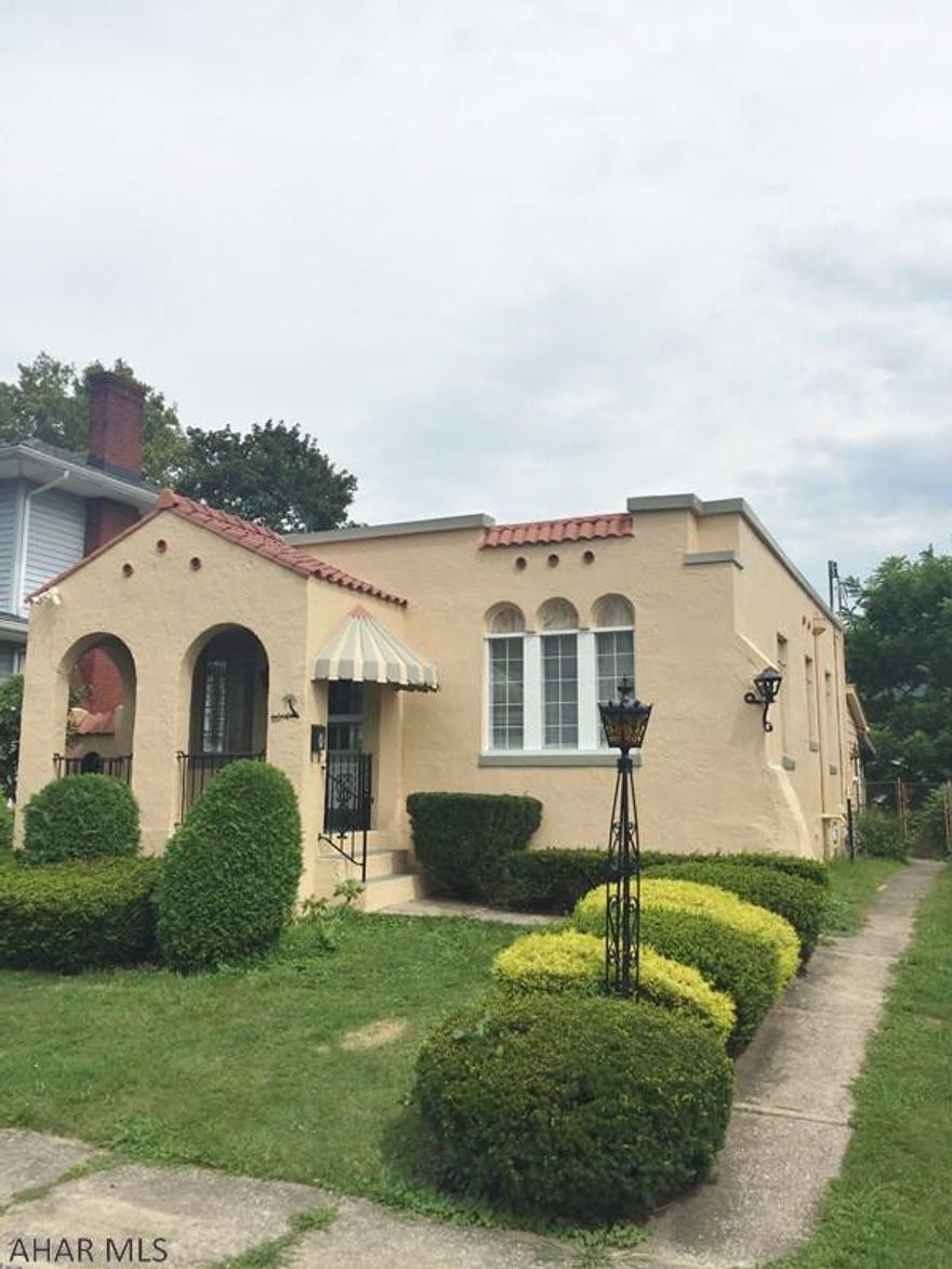 Unique Spanish style home located on a tree lined street in Hileman Heights. This 2 bedroom 2 bath home is perfect for anyone looking for a non cookie cutter home! Original hardwood floors are found throughout the main living areas, the kitchen has an eat in area and pantry closet and the main bath has been updated. There is a sun porch to the back of the home that was used for a home office space. The lower level has been freshly painted and has brand new plush carpet, there is a decorative fireplace located in this area also. Central AC, newer rubber roof, freshly painted exterior, covered front porch, fenced yard and detached garage.