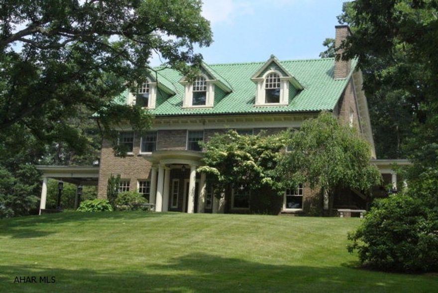 One of Blair County's finest homes...this estate boasts over 8200 sq ft of charm, quality and beauty.  Features include hardwood floors, beveled glass pocket doors and French doors that lead to an enchanting veranda (complete with tile floor and fireplace). The kitchen has been updated with a Viking stove, Sub-Zero ref and 2 prep sink areas...there is a Butler's pantry adjacent to the kitchen with hardwood floors, granite c-tops and lighted shelving for displaying glasses. The Library, Dining rooms and living room are nothing less than stunning.  Each bedroom on the 2nd floor has an en suite bath and the third level has 2 living suites...perfect for in-laws or older children. Also on the 3.2 acre lot is a stone 3 car garage with mechanic's pit and a full apartment above.