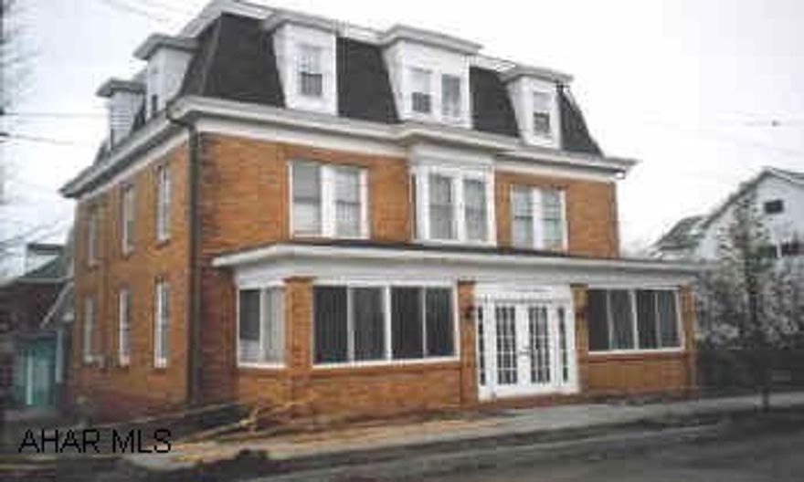 3 story brick home on corner lot. Carport & newer roof