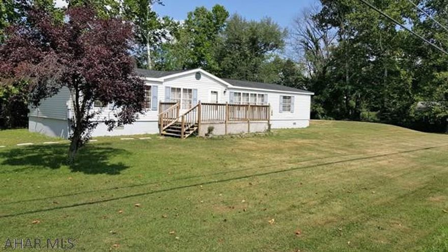 Close enough to the places you enjoy, yet private enough to provide some peace and quiet.This well-maintained double wide is located in the West Loop of Hollidaysburg, is situated on a level lot and is on a full foundation.  The living room features a beautiful wood burning fireplace, book shelves, and provides lots of space for entertaining. This property features laminate flooring, and includes walk-in closets in each of the 3 bedrooms. A new shower has been installed in the master bedroom, which also features a large garden tub.  After a long day, enjoy either the front or rear decks.  In addition to the rear deck,there is plenty of room for a great bon-fire with family and friends, or simply sit back and enjoy the beautiful steam that runs along the property.