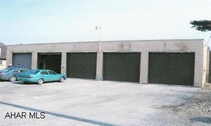 Good storage garage.  High ceilings, overhead doors, and dividing walls.  Any commerical use is subject to a variance. 78'x40' concrete block garage with five 12' overhead doors.