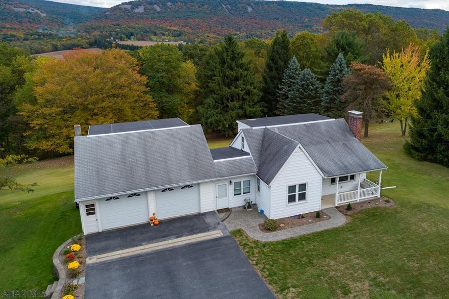 This 1 1/2 story home has been loved and cared for since 1950's.  Seller's parents lived in basement until they started a family, adding an oversized 2 car concert floor garage (27'10x27'4) with a 27'8x21'9 work space above garage.  Sun Room, 1st floor bedroom and 1st floor bathroom, Living Room with a brick fireplace, dining room with built in cabinet.  2nd Floor has two bedrooms with hardwood floors and a half bath.  Basement is a 12 block high ceiling with a walk out.  Home owner was a fan of race cars and rebuilding tractors adding a garage/workshop off basement.  All of this is located on 2.75 acre of ground that can be viewed from this home.   Fire circle area included in sale. Hollidaysburg SD.