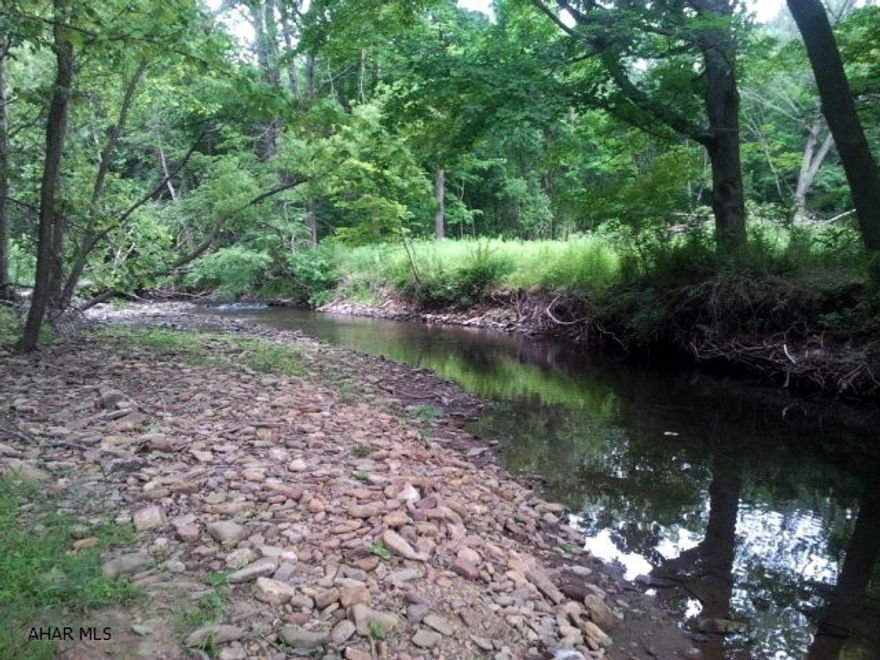 3.1 acres with stream for excellent fishing. Great hunting area. 14' x 40' building with a new metal roof and potential to be a future cabin.