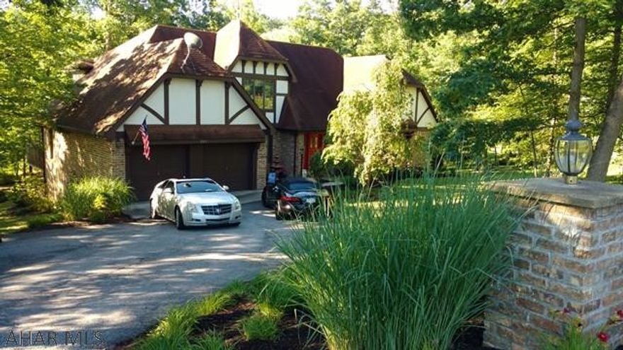Beautiful Tudor Style Home on Baker Lane in Altoona. Solid oak Doors, Trim and Cabinetry throughout the house! First floor Master bedroom and Bath. Great kitchen with Breakfast nook that has doors to the Private rear deck. Huge Dining Room with Gas Fireplace...this room could also be used as a family room. Cozy Living Room, laundry, Den/Office and Guest Bath...New Light Fixtures...That's just the first floor! Second floor has 2 nice sized bedrooms and full bath. Full finished basement with Wet Bar and double sided Gas Fireplace, 4th Bedroom or Den/Office, full bath and tons of storage. Did I mention the oak? Large two car garage with attic pull down for more storage. The lot is just under an acre. It's gorgeous! Park like atmosphere and Private.