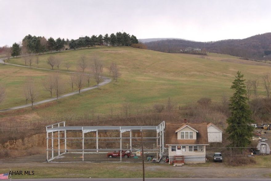 Many possibilities for this property that sits on a high traffic road close to I-99 and East Freedom Walmart. There is a 60 x 80 steel structure, 3 bedrooms home and a 2 car garage, over an acre lot with low taxes. The adjoining property is also for sale.  Seller will consider any reasonable offer.