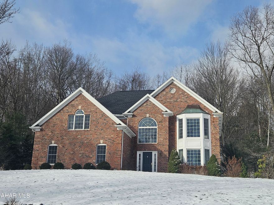 This magnificent home in Hickory Terrace showcases exceptional quality and craftsmanship throughout. The grand two-story entrance, featuring tile floors and oak trim, welcomes you with a walk-in coat closet, setting a refined tone for the rest of the home. Custom millwork walls add depth to the entryway, visually balancing the open loft area above.

The kitchen is a chef's dream, outfitted with a six-burner gas Wolf range oven, KitchenAid refrigerator/freezer, and cabinetry with convenient pull-outs. The beautiful custom cabinets are topped with granite and are complemented by a custom tile backsplash.  The space seamlessly flows into the sunken family room which boasts a large arch-topped doorway, hardwood floors, and a brick-surround wood fireplace that is framed by two newly created windows,  The room is filled with natural light from the adjoining three season room.  A vaulted, planked ceiling with brand new skylights tops the private three season room that opens to an extremely private patio.

Enjoy meals in the formal dining room which opens to the bright living room.  The second floor opens to a spacious landing that could be a cozy lounge area. Currently used as an office, the front room on the second floor could easily be converted into a fourth bedroom. Each of the three bedrooms has been thoughtfully updated with its own remodeled bathroom.

The master bedroom is a standout, featuring two large walk-in closets and a treyed ceiling. The vaulted ceiling master bath boasts a stunning tile and glass-doored step-in shower, along with a free-standing tub. A second bedroom, with dramatic ceiling lines and a full-length closet, could serve as a second master suite.

The laundry area, conveniently located on the second floor, includes a work sink and cabinetry, while the generously sized hall offers a large linen closet. Storage is abundant throughout the home, with ample closet space, garage storage, and a spacious basement that offers potential for additional living areas. The tree-lined backyard provides privacy, complemented by a secluded patio perfect for outdoor enjoyment.

This home is an ideal combination of beauty, function, and practicality.