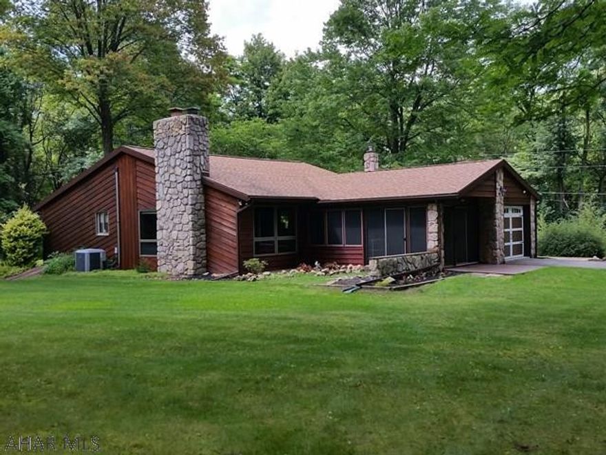 Great 1-story 3-bedroom 2.5-bath cedar-sided home with vaulted ceilings, wood burning fireplace, built-in 9x9.5 bookcase, screened-in patio, skylights, heated & air conditioned sunroom, 1st-floor laundry, 1-car attached garage plus detached 1.5-car garage with extra utility door + 3-season half bath and screened-in patio area, breakers, and central air. Shed with electric. Nicely landscaped parcel in a country setting. Taxes are estimated per ReAssessment at $3,172 for 2017. J-395