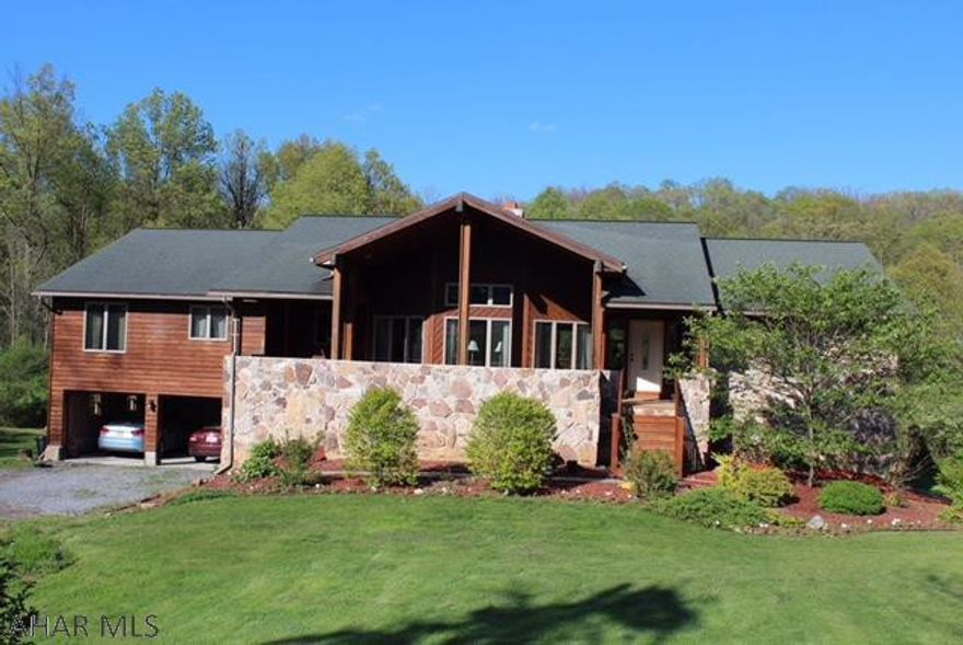 Quality craftsmanship throughout this beautiful contemporary 4 bedrm, 3 bath home on 2.14A. Tile floors though out the house except the bedrooms. Great Rm has beautiful Hickory floors and stone fireplace . Kitchen has custom rustic pecan cabinetry and ss appliances. Sep. dining area along with a sitting area with vaulted ceiling and sliders to a 18x28 deck overlooking a private back yard. M suite has a large walk-in closet, bath with Jacuzzi & sep. shower, his & her vanities. The enormous lower level could be easily finished.   Two  car garage. Bonus storage area under the front deck.4 zone GHW heat, UV light and radon system.A beautiful private setting yet minutes from Frankstown elementary school and Hlbg. Borough.This is certainly not your typical cookie cutter house.