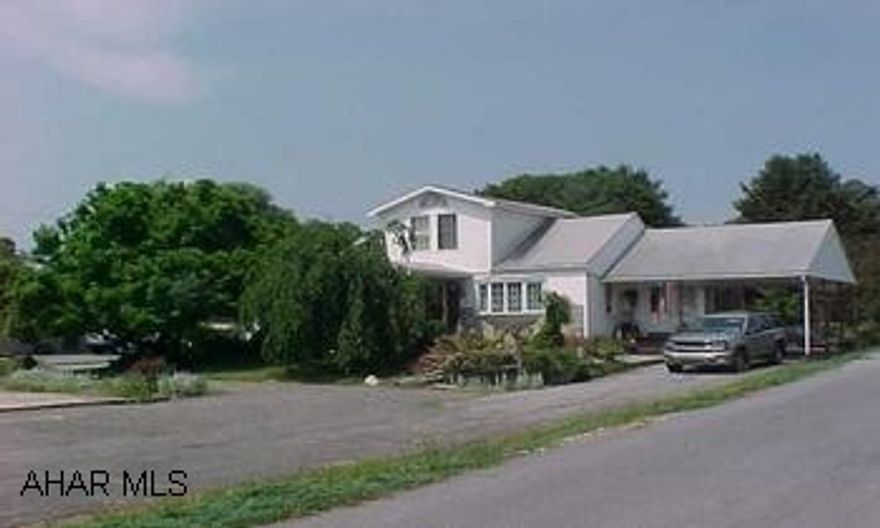 This is a Commercial site 100 x 974 - 2.24 acres across from Tractor Supply. 3 sewer taps. There is a nice 1 1/2 story home on it with a rear shop. Seller will look at all offers. Seller may consider Lease to property.