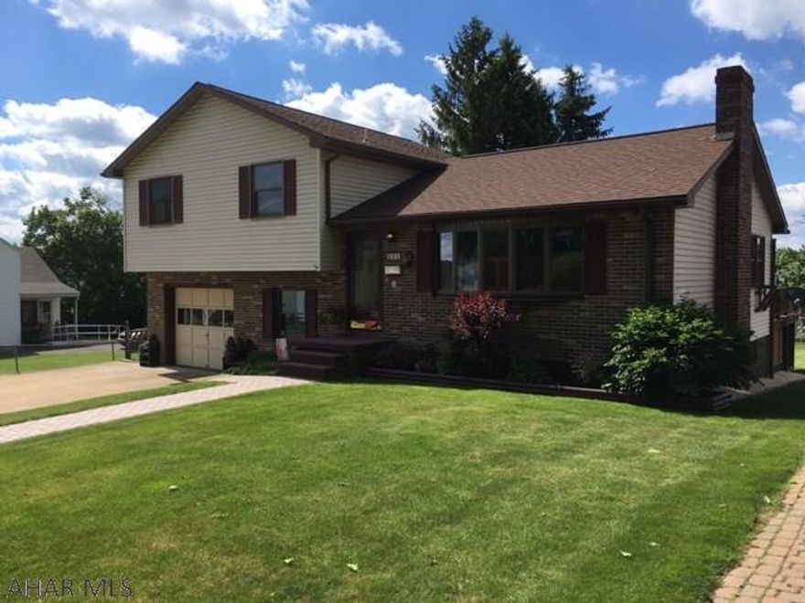 Stylish split level home on  manicured lot.   Living room features hardwood floor and steps.  semi-finishing basement with a half bath..Home also has den/office/laundry area off of garage as well as attic area...backyard area has a large deck with roof and 2 patio areas for entertaining ...large fenced in backyard with shrubs and garden that  adds the perfect touch....call to schedule your tour of this well built move-in ready home..