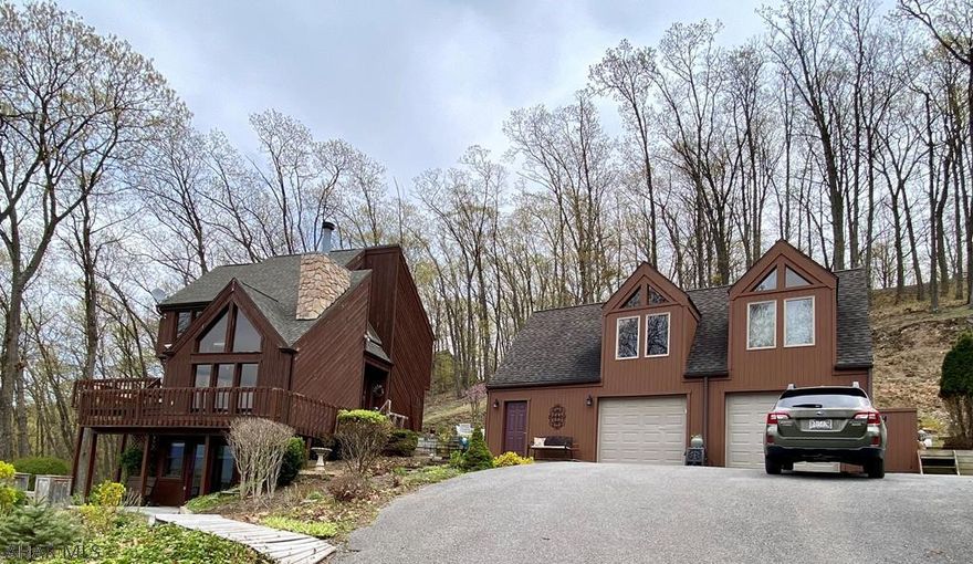 "If you're lucky enough to live at the lake, you're lucky enough" You could be lucky enough to make this beautiful lake home yours. Don't miss out on this Beautiful, pristine mountain top home in Shy Beaver Lakeview Estates with modern updates, new kitchen with stainless steel appliances, and 3 newly renovated bathrooms. Enjoy an ice cold lemonade on one of several outdoor decks in your very own tree house on top of the world. On those crisp fall evenings, lounge by the stone fireplace and take in the mountain view. This home also boasts a large two car garage with a heated workshop as well as a beautiful studio apartment with 3/4 bath above garage. There is also an adjoining lot being sold separately for an additional .92 acres of wooded serenity. You may never want to leave the mountain!