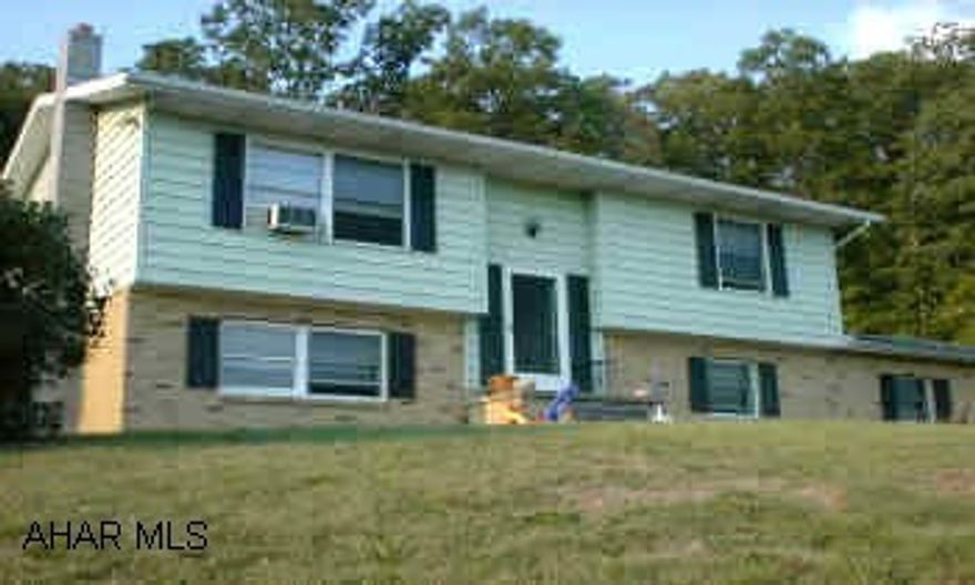 At the dead end of W. 21st Street--Right up hill One acre bi-level with private setting and great view.  Country living with city amenities.  Owner willing to help with buyer's closing costs.  Call Gene Pine for details.