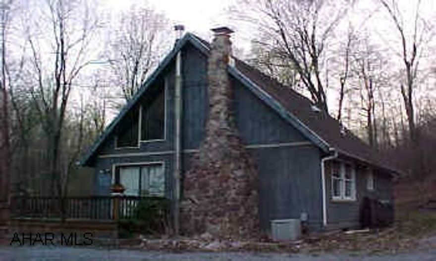 A-Frame on 4 acres. Needs work, nice setting, very private. Stream in front of property.