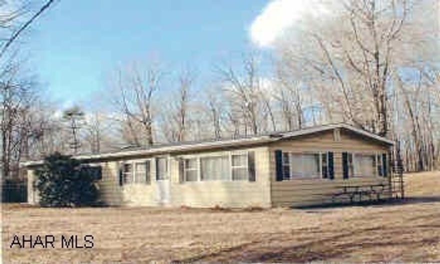 Well maintained doublewide on secluded hilltop setting surrounded by 43.5 wooded acres with stream and 1/2 mile of road frontage. Newer shed  14'x28' with roll up door.