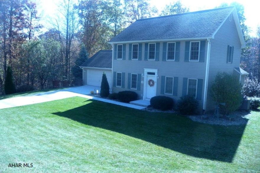 Charming two story colonial w/ 3 BR, 2.5 BA in prestigious Ridgewood Subdivision. This home offers a beautiful oak kitchen (eat-in) w/ HW flooring, work island, recessed lighting and convenient pantry. The downstairs includes an adjoining family room w/ propane gas fireplace, a half bath, formal living room and a formal dining room w/ HW floors and chandelier. The second level provides a master suite w/ walk-in closets and full bath. The rear of the property offers a spacious retreat area with a two level deck, an attached above ground pool, a large concrete patio with accompanying pergola and a quality child's play gym all surrounded by beautiful landscaping and large shade trees. A high efficient heating system and added insulation will help keep the fuel cost down for this property.