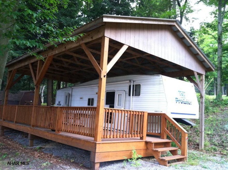 Escape to this 5th wheel under a beautiful custom-made 32' by 26' pavilion with a huge deck under roof that sits on 2 deeded lots.  This air-conditioned camper sleeps 8.  All the amenities of Glendale Yearround gated community are at your disposal.  The lot has a fire ring for summer camp time enjoyment.  Besides the shed, the unit has lots of built in storage.  The 3-burner stove with oven is propane, and the refrigerator and hot water heater operate on either electric or propane gas.  Electricity is supplied by REA and averages $35-$40 a month when the camper is being used.  Water and sewage run $50 a month.