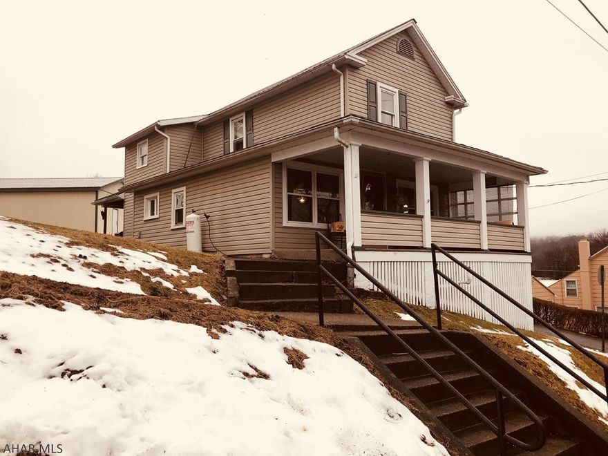 Quaint, cozy and comfortable are just a few words to describe this charming home located just minutes away from Raystown lake.  This 3 bedroom home offers an oversized 2 car garage that can house a boat as well.  When entering this home, one will be amazed at the amount of space this home has to offer.  Laundry room conveniently located on the main floor.  Newly restored kitchen provides abundant counter space for food preparation.  Two covered porches provide extended entertainment space that will please even the most discriminating buyers.  This is a must see home.  Won't last long.