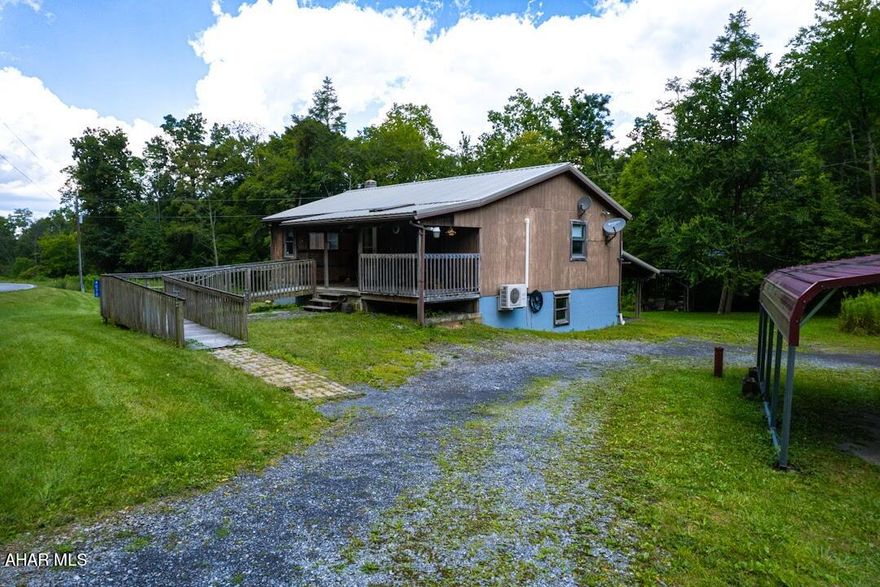 Here's your chance to have that ranch home on 1.65 acres with a running stream! This wood sided, 3 bedroom, 1 full bath ranch home offers country living. Located right at the foot of Snake Spring Mountain, this home has a large yard for plenty of play for the children or for family gatherings. Enjoy the stream that runs on the back of the property! 
Steps or a ramp to use for the front porch. Open living area with a mini split to stay cool on the hotter days. Third bedroom was made into a laundry area, but can be easily resorted back to a bedroom. All rooms have been professionally painted. 
An unfinished but heated and cooled basement is ready for you to make into a game room, family room, work out room or whatever you need! There's a 10x8 root cellar under the porch for your canned goods. An area of the basement is plumbed for a 3/4 bath. Also hook up for a washer/dryer. A utility room with a 2017 whole house water softener. Additional breaker box and storage area.
At the back of the house is a one car lean-to with access to the back door. There's also a 2 car carport to keep your vehicles out of the weather. This property also includes a large, 2 bay garage with electric that can accommodate an air compressor and welder hook up; workspace, a mechanics pit and room for a second floor office. A garage door at the back for easy access also.
This home is waiting for its next family to create memories in. Located in the NBC school district, beautiful cove farms and friendly neighbors make this an ideal place to live!