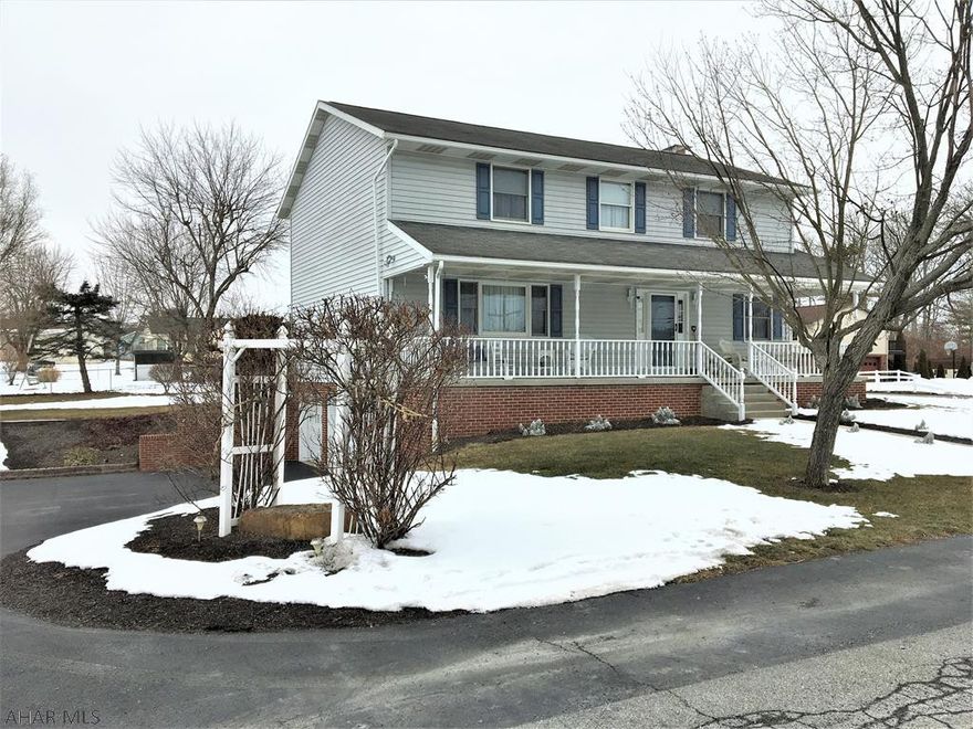 Immaculate vinyl/brick  2 story w/4 bedrooms and 4 baths. Easy care maintenance and landscaping. Relax swinging on the inviting front porch, rear deck, paved drive w/2 car integral garage. Walk in the front door to a tiled foyer, spacious living room, formal dining room, eat- in kitchen with stainless appliances. Cozy family room with wood fireplace. Main level laundry. Upstairs has large master bedroom w/ private bath and walk -in closest. 3 extra spacious bedrooms and full bath. Walk up attic storage. Basement is partially finished with a wood stove, half bath and more storage, plus 2 car garage. Heated with F/A heat pump with central air. Don't miss out on this one!!