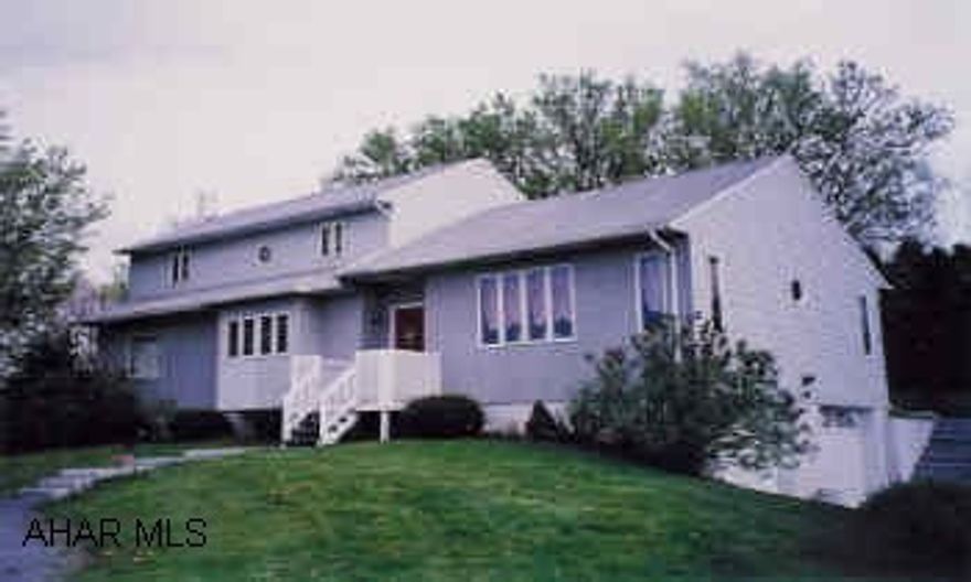 Completely renovated Tri-Level Contemporary, 4 BR, 2BA, 3 garages, Sunroom Office, Large Rear Deck Features raised living room, master suite with jacuzzi, cedar paneled sunroom with skylights, main-level laundry. Kitchen, breakfast nook, private office/den, home warranty package.