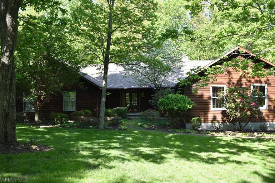 Light and space are the hallmarks of this custom home on 1.17 acres in the Stonehedge development. One story living at its best in a secluded, natural setting!  Vaulted ceilings with skylights, open floor plan and gorgeous hardwood floors! Enjoy the beautiful stone gas-fired fireplace from either side..in the dining area or, the great room!  Partially covered,wraparound deck and the woods out your back door!  2 car attached garage. Close to shopping, restaurants, golf, Canoe Creek State Park and bike/hiking trails. New furnace in the fall of 2016. Carpet replaced in main floor hallway and master bedroom in May of 2018. This home is waiting for your special touches to make it your own! Buyer to verify measurements.  Agent is related to seller.