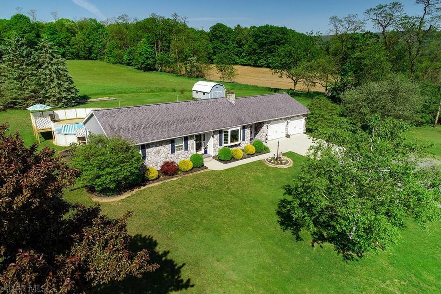 Meticulously maintained three bedroom, one level home with gorgeous views on 6 acres. Inside highlights, new floating tile floor, large bay window with custom draperies offering views of the country setting, cherry cedar walls, tilt in windows, new carpet in basement and basement is plumbed for a bathroom, Schrader wood burner with electric heat back up, brand new electric panel. Outside features, new carpet on porches, above ground pool with deck, french doors from dining room lead to a covered stone patio, side yard offering mini orchard with two apple trees two pair trees and two black cherry trees plus concord grape arbor and raspberry bushes. Fragrant flowering trees and bushes, beautiful landscaping with flower beds that bloom the entire growing season...This home is a MUST see!