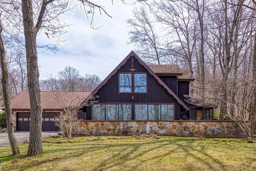 Peaceful living in A-Frame home on -1 acre lot.  Wooded lot surrounding with stream flowing thru small wooded ravine, sitting area to enjoy nature.  Home has plenty of space with 4 bedrooms, 2.5 baths (2 bedrooms 1st floor and 2 bedrooms 2nd floor.) 1st floor laundry - walk out to back yard, vaulted beam ceiling in Great Room, Stone faced fireplace, Dining Room has hardwood floors & wall of windows to enjoy setting, eat in kitchen with semi wrapped deck, covered deck area to enjoy your morning beverage.  Some finishes in basement - walk out basement.  2 heat pumps, 1st floor and 2nd floor.