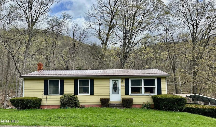 This ranch home has many updates and is situated next to Gladdens Run stream.  Features a new oil furnace, metal roof, wood burning furnace, laminate flooring in the living room, a finished basement with walk-out, a galley kitchen with Hickory cabinetry and a 10x16 wood deck off the kitchen that over looks the stream and woods.  In addition to the property is a 18x18 carport, 12x12 and 8x16 sheds.