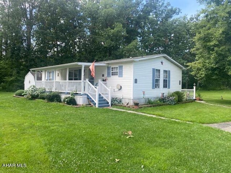 Imagine living in this established 1990, 2 bedroom, 2 bath, double wide nestled in a 55 and over community. Friendship Village has so much to offer. This home is on a rented corner lot with views of the entertainment building. Sit on your own front porch swing and watch the shows. New hardwood laminate throughout most of the home. Use the 3 season room for most of the year to entertain or relax. Oil, forced air heat if needed. Newer mini split heats and cools the entire home. Central air is available, and could easily be hooked back up. Master bedroom has hardwood floor and a master bath and walk in closet. Storage shed included. Rented lot is $300/month and buyer must be approved with Friendship Village before purchase of home.