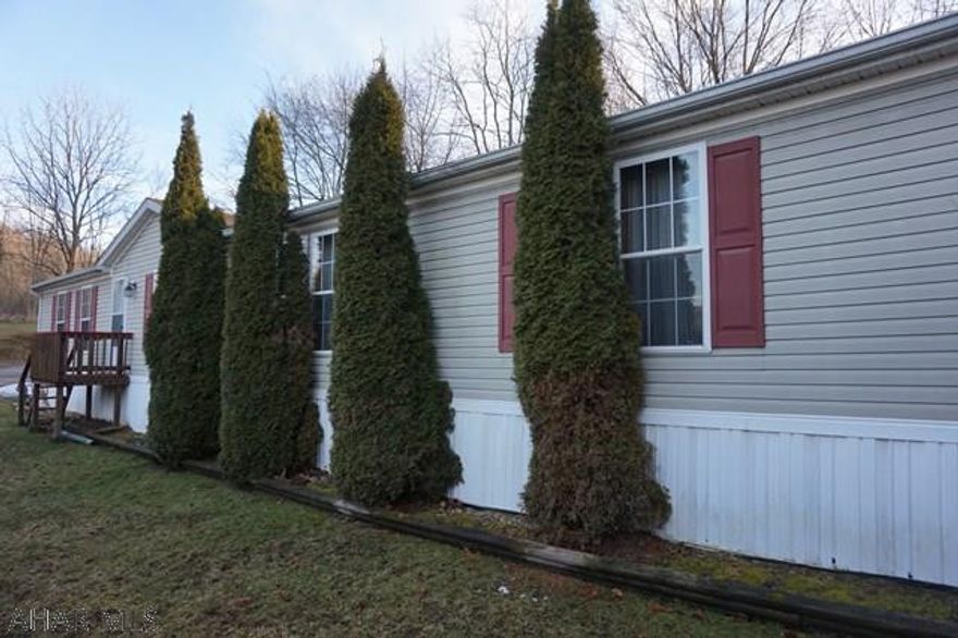 THIS IS A MUST SEE! Spacious and open well maintained 3 bedroom 2 1/2 bath double wide in Camelot Woods, Beautiful kitchen with eat in area, Large formal living room. Nice family room off Kitchen. Spacious master bedroom with master bath and walk in closet.  Attractive setting with off street parking. Call listing agent today for your viewing. Lot rent includes sewer and trash.