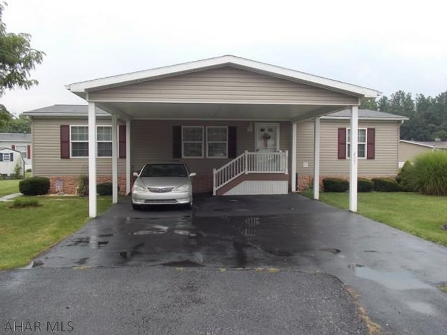 This home is in like new condition, beautifully cared for and well maintained. Lots of storage and counter space, deck and two porches are maintenance free. Huge carport is vinyl and keeps at least two cars out of the weather and you dry while unloading groceries The matching shed has plenty of room for your mower and extra stuff.  Located in a lovely quiet neighborhood where neighbors look out for each other. Close to Martin's Grocery store, The Meadows and other restaurants. Great place to spend retirement years.  This one must be seen to be appreciated. Nothing to do but move in and relax. Lot rent is $381 per month.  Flood insurance may be required if buyer gets a mortgage.