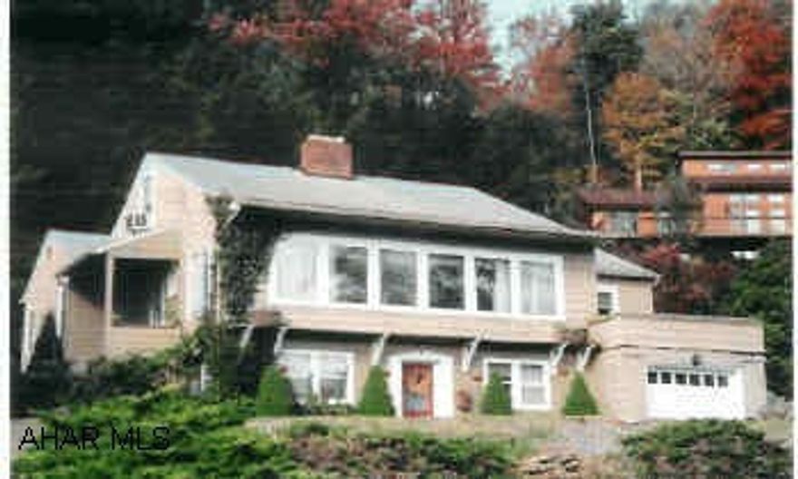 Outskirts of town. Has lots of potential, hardwood floors, gas fireplace. Great location, lots of potential, central air. Fish pond in rear, side fenced area for play yard, paved drive.