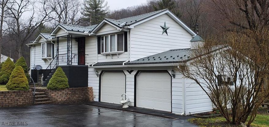 Bellwood Antis School District raised ranch house.  3 bedroom, 1 bath, 2 car attached garage and metal roof.  4.17 acres with storage garage and 2 green houses, new septic system and well.  Spacious living area, covered porch, gazebo, small stream on property.