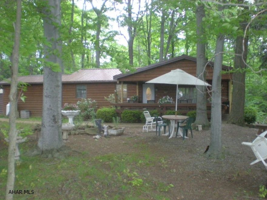 2 Br rancher on wooded lot. Paved drive, large deck, detached garage and woodworking shop. Well maintained home.
