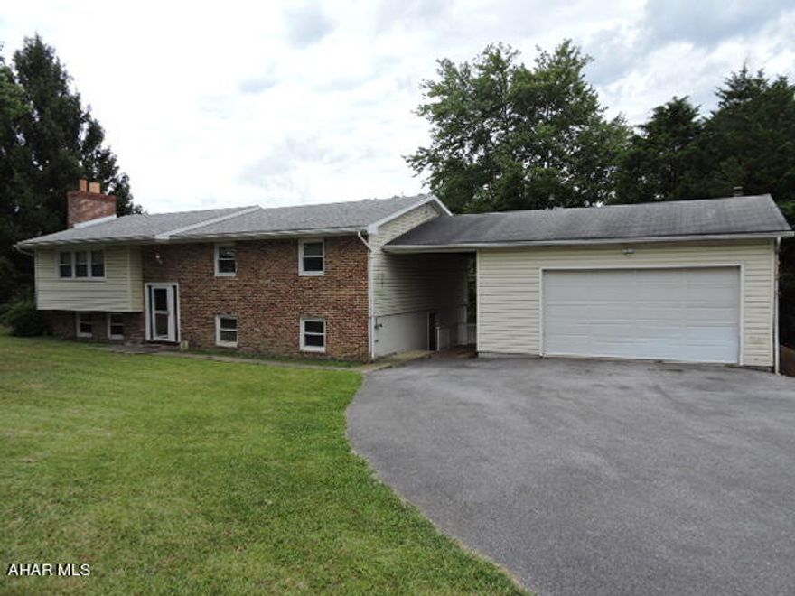 Reduced for quick sale due to out-of-state owners. This car-lover's dream house features an oversized 2 car HEATED garage + utility garage in bsmt. Ideal for working on classic cars during Pennsylvania winters.  Make memories in this bright 3BR 2BA bi-level.  The generous living room features a hand-crafted brick fireplace. The MBR has a bright brick accent wall and an updated ensuite ba.   Positioned on 1.3 acres, this hilltop house offers beautiful views of rolling hills from the spacious eat-in kitchen with knotty pine cabinetry.