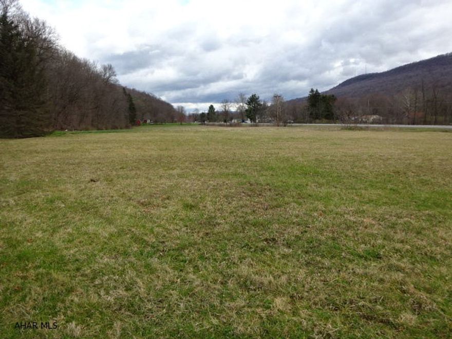 Flat land with no zoning with frontage on Dunnings Highway between East Freedom and Claysburg. No well or septic. Listing agent to check with township concerning access to public sewer. There is an easement for lane access to property behind the land. This is land only. The ranch home behind is an adjoining property.