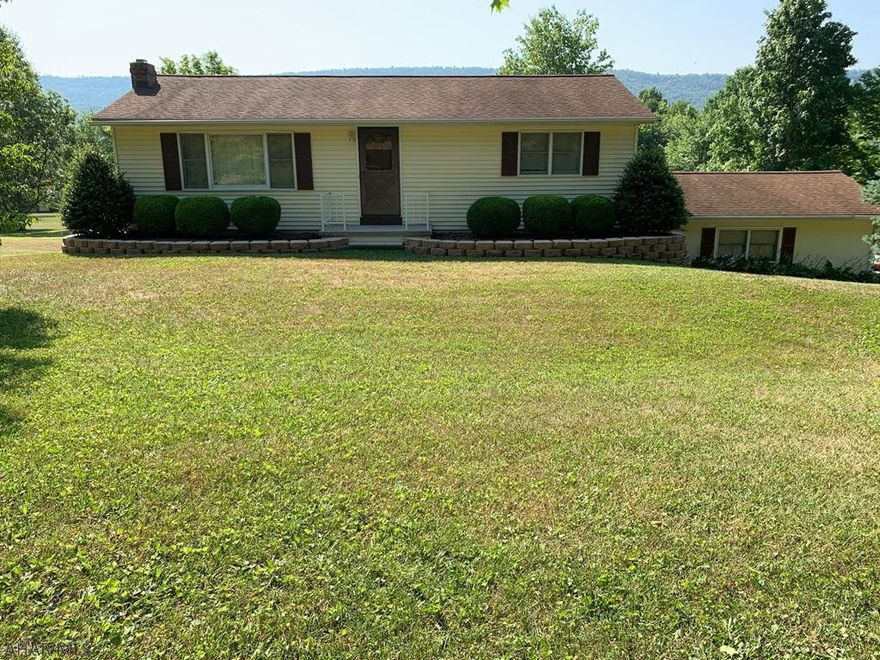 A corner of comfortability awaits for you!  Make this 2 bedroom, 2 bath easy living home yours today. Enjoy an eat in kitchen, a spacious dinning room and large living room. Full finished basement including plenty of space for more living area, laundry, workshop and full bath. Easy accessible entrance from the attached garage to basement. Relax on your large deck with gorgeous views!  Situated on 1 acre located just minutes away from downtown Bedford and the Bedford Springs.  Make this your Home Sweet Home today!
