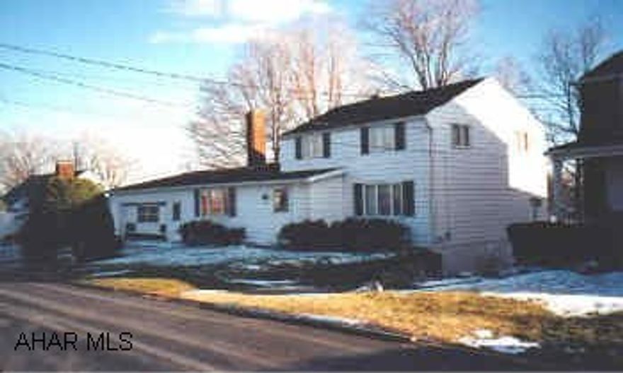 1 1/2 story aluminum sided home Very well maintained home in Elderwood. Beautiful cut stone fireplace in Family room. Large lot. Oversized garage.