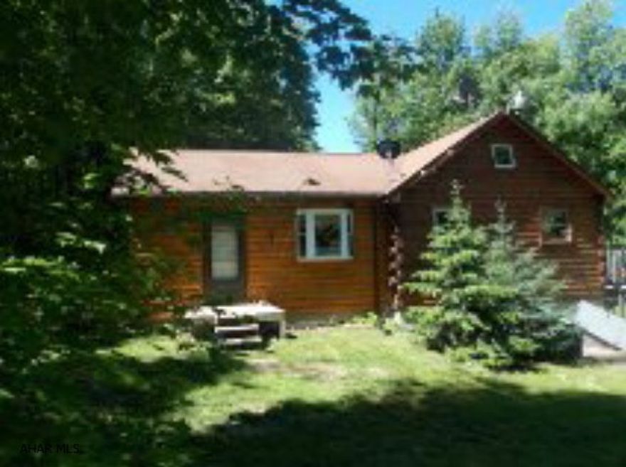 Hastings: 514 Spruce Road Extension. A nice log cabin with addition on almost 2 totally secluded acres in the country. Wildlife galore. Country kitchen with appliances. 3 bedrooms. Has an additional loft for a game room. Half finished basement with pool table and wood burner included. Oil HA heat. Shed and dog kennel.