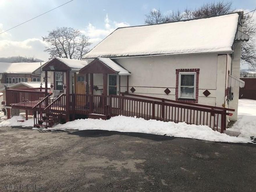 This cozy 2 bedroom 2 bath home is zoned residential business. It offers a large living area that could be used as a living room or as an office which has hardwood floors and lots of light from the 3 large half circle windows, a dining room, kitchen with unique back splash,1 st floor laundry, bedroom, and updated bath. 2nd floors offers a full bath and bedroom. Newer roof, updated electric, deck and large shed and a large paved lot for parking and a handicap accessible ramp.