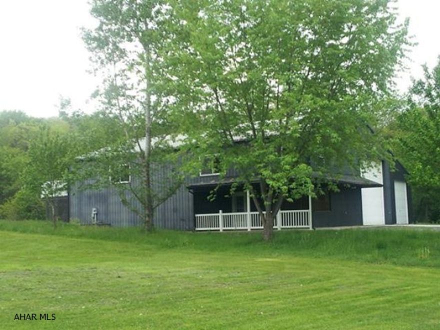 Residence w/ excellent business potential. Great location on 3 acres. Lovely & spacious one bedroom home w/ several bonus rooms that previously were used for an office & waiting room for an auto mechanic/towing business, but has many other business possibilities. The bonus rooms could also be used as add'l living space. This property has a 26'x60'x16' attached garage w/ a 14' garage door and complete w/ drywall and heat. PLUS another 14'x60' bay garage. Seller is including a 9000lb two post vehicle lift. The second floor is spacious w/ a kitchen/dining combo, living room, one bedroom and a modern bath with over sized tub. It also has nice flooring, custom woodwork, a covered porch and a 10'x15' deck. This 3 ac property has a nice setting and is less than 5 min to downtown Bedford.