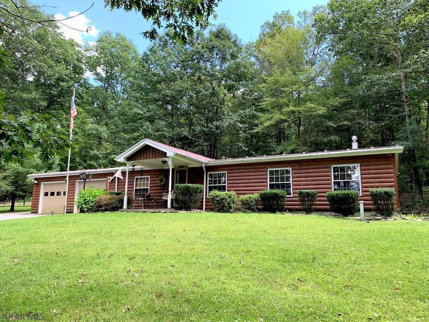 Very well maintained and cared for one-story double wide home resting on .688 of an acre. This log sided home offers a living room, kitchen w/ updated hickory cabinets and eat-in area, family room w/ fireplace, master bedroom suite w/ master bath, two additional bedrooms, a full bath and a laundry area. Over-sized two-car garage, front covered porch, rear covered porch and macadam driveway. Home rests on a concrete block crawl space, has thermo pane windows, oil forced air heat and central air-conditioning. Private tree lined lot, close to Trough Creek State Park, Lake Raystown, and state game lands.