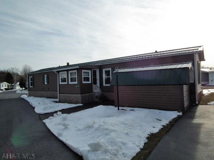 Beautifully maintained!  This mobile home in Eldorado 55+ Mobile Park has insulated vinyl siding, all newer windows, lifetime guarantee metal roof, attached garage, 8x12 storage shed w/electric, decorative skirting, open floor plan - see pictures - electric lawn mower, ladder & tools included.  Available for closing after March 9th.  $304 Lot Rent, Sewer - $19.70, Water - $27.14, Natural gas average - $43, Electric - $63