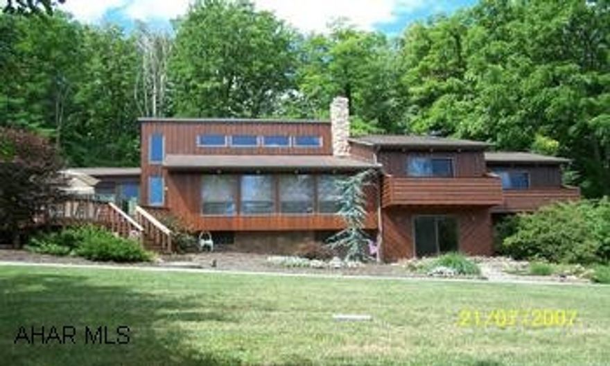 5 private Acres and great mountain view!!  Wonderful 3 Br. 2.5 Ba, Contemporary home with a unique floor plan design.  Open kitchen overlooking living room w/fireplace and 2 of the bedrooms have their own balcony. Terrific finished lower level w/wet bar and woodstove - Great for entertaining! Hot water heat and a nice 2 car garage are just a few of the amenities in this special property. Call Linda Adler 814-329-3076